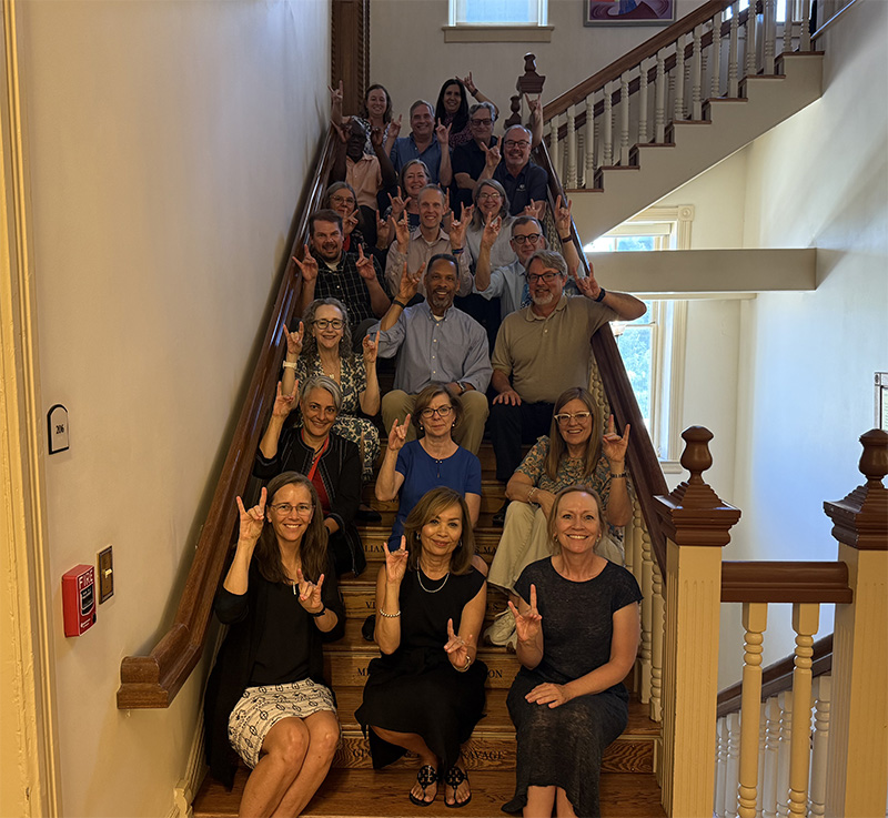 provost office employees sitting on staircase